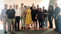 A group of men and women of various ages pose together